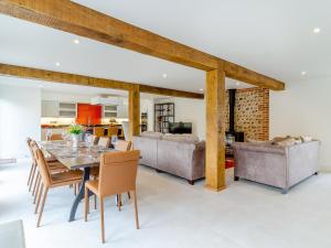 a dining room and living room with a table and chairs at Kestrel Barn-Uk31353 in Swaffham
