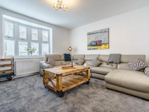 a living room with a couch and a coffee table at Wynbec Cottage in Esh