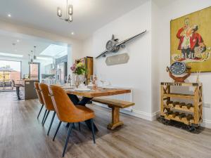 a dining room with a wooden table and chairs at Wynbec Cottage in Esh