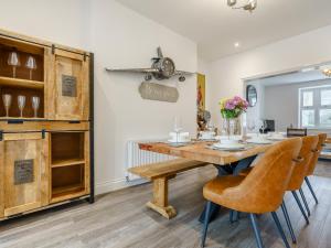 a dining room with a wooden table and chairs at Wynbec Cottage in Esh +27 photos