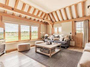 a living room with a couch and a table at Lovington Barn in Ovington
