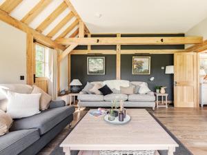 a living room with two couches and a coffee table at Lovington Barn in Ovington