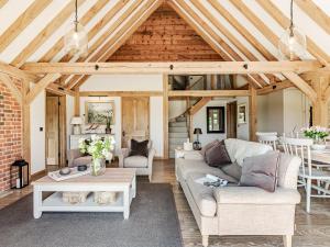 a living room with a couch and a table at Lovington Barn in Ovington