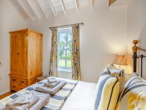 a bedroom with a bed with towels on it at The Stables - Uk47151 in Burgh le Marsh +6 photos