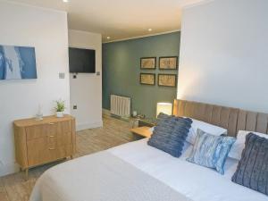 a bedroom with a bed and a tv on a wall at The Village Hall in Consett