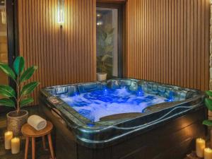 a large blue tub in a room with a plant at The Village Hall in Consett