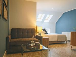 a living room with a couch and a bed at The Village Hall in Consett +17 photos