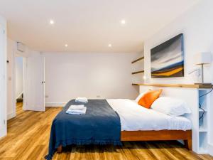 a bedroom with a bed and a painting on the wall at Priory Street in York