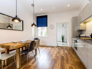 a kitchen and dining room with a wooden table and chairs at Priory Street in York