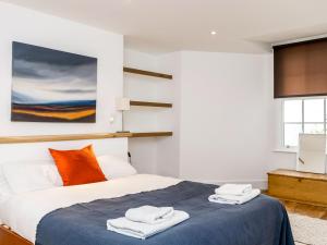a bedroom with a bed with towels on it at Priory Street in York