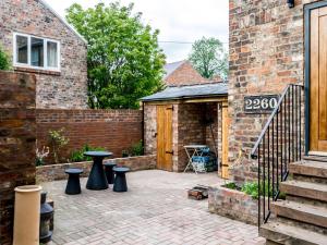 a patio with black stools in front of a building at Priory Street in York +4 photos