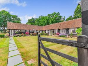 a house with a fence in front of it at The Pool House - Uk49372 in Send