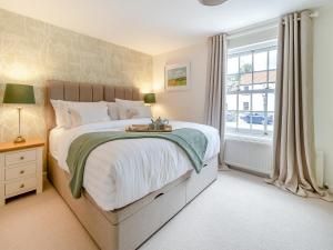 a bedroom with a large bed and a window at Mrs Cracker's Cottage in Lund