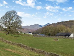 a field of green grass with mountains in the background at The Old Chapel in Ulverston