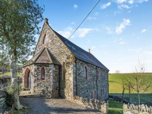 an old stone church sitting in the middle of a field at The Old Chapel in Ulverston
