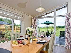 a dining room with a table with food and wine at Holly Lodge in Hassocks +14 photos