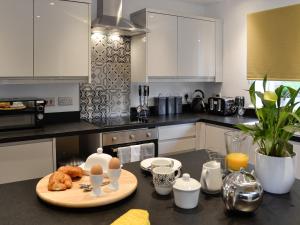 a kitchen with a table with eggs and croissants on it at Bryn Aled in Llanfachreth