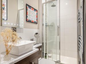 a bathroom with a sink and a shower at The Dairy - Ukc3780 in Hickling