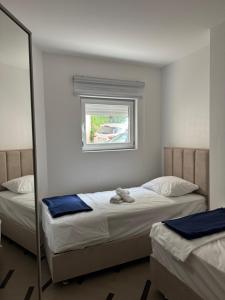 a bedroom with two twin beds and a mirror at Green Oasis Budva in Prijevor