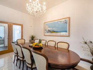 a dining room with a wooden table and chairs at Babbacombe House in Torquay