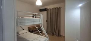a small room with a bunk bed with a ladder at Aleka Apartment in Kos