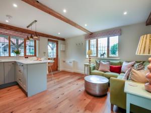 a kitchen and living room with a couch and a table at Keeds Barn in Arundel