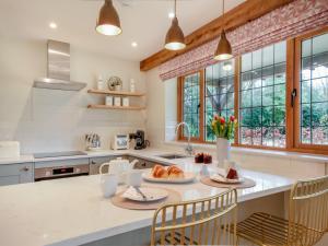 a kitchen with a large island with a table and chairs at Keeds Barn in Arundel