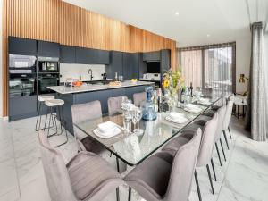 a dining room with a glass table and chairs at Seabreeze in Saint Mawes +29 photos