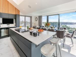 a kitchen with a large island with a counter top at Seabreeze in Saint Mawes