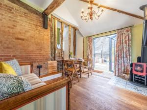 a living room with a brick wall at The Old Press - Uk50806 in Halesworth