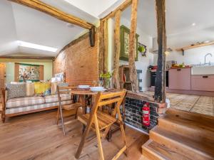 a kitchen and living room with a brick wall at The Old Press - Uk50806 in Halesworth
