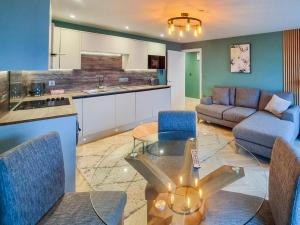 a kitchen and living room with a glass table at Uk47853 - No 2B in Aberystwyth