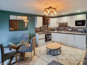 a kitchen and dining room with a table and chairs at Uk47853 - No 2B in Aberystwyth