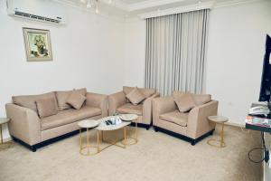 a living room with two couches and a table at روعة نجد القدس in Riyadh
