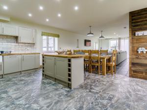 an open kitchen and dining room with a table and chairs at The Millhouse - Uk32510 in Marloes