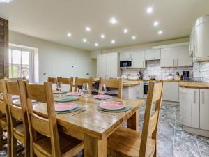 a dining room with a wooden table and chairs at The Millhouse - Uk32510 in Marloes