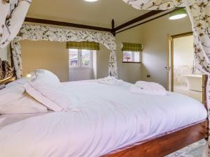 a bedroom with a large bed with white pillows at The Millhouse - Uk32510 in Marloes +28 photos