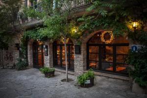 a building with windows and plants in front of it at Ca la Genoveva in Montsonis