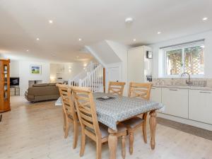 a kitchen and dining room with a table and chairs at Willow Cottage - Uk39244 in Inverness +15 photos