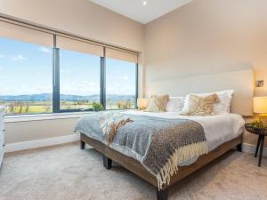 a bedroom with a bed and a large window at Hayloft - Uk49529 in Buchlyvie