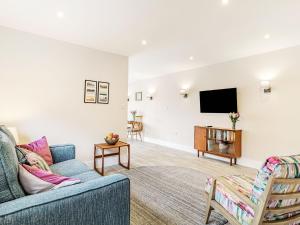 a living room with a couch and a tv at Wisteria Lodge - Ukc5804 in Shelfanger