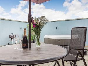 a table with a bottle of champagne and two wine glasses at Wisteria Lodge - Ukc5804 in Shelfanger