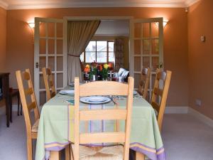 a dining room with a table and chairs and a window at The Palm in Seasalter