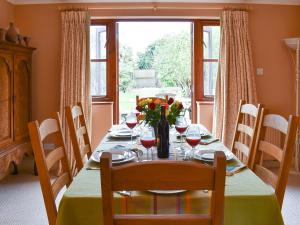 a dining room table with wine glasses and flowers on it at The Palm in Seasalter +25 photos