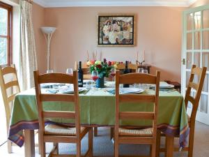 a dining room table with a green table cloth at The Palm in Seasalter