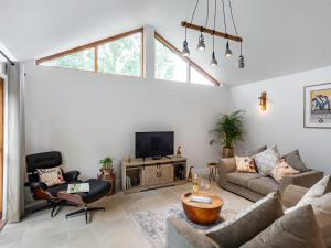 a living room with a couch and a tv at North Farm Lodges in East Mersea +23 photos
