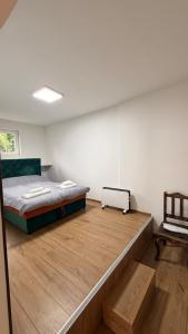 a bedroom with a bed and a wooden floor at Baklava in Sarajevo