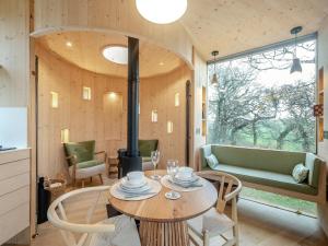 a room with a table and chairs and a window at The Treehouse Caerlaverock - Uk45028 in Carsethorn