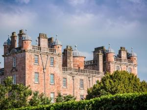 a large brick building with domes on top of it at Stableyard Studio - Uk7173 in Carronbridge +3 photos