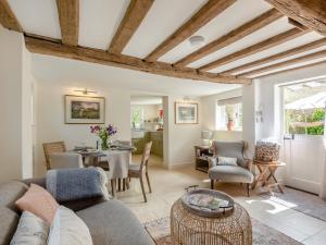a living room with a couch and a table at Hope Cottage in Ilketshall Saint Andrew